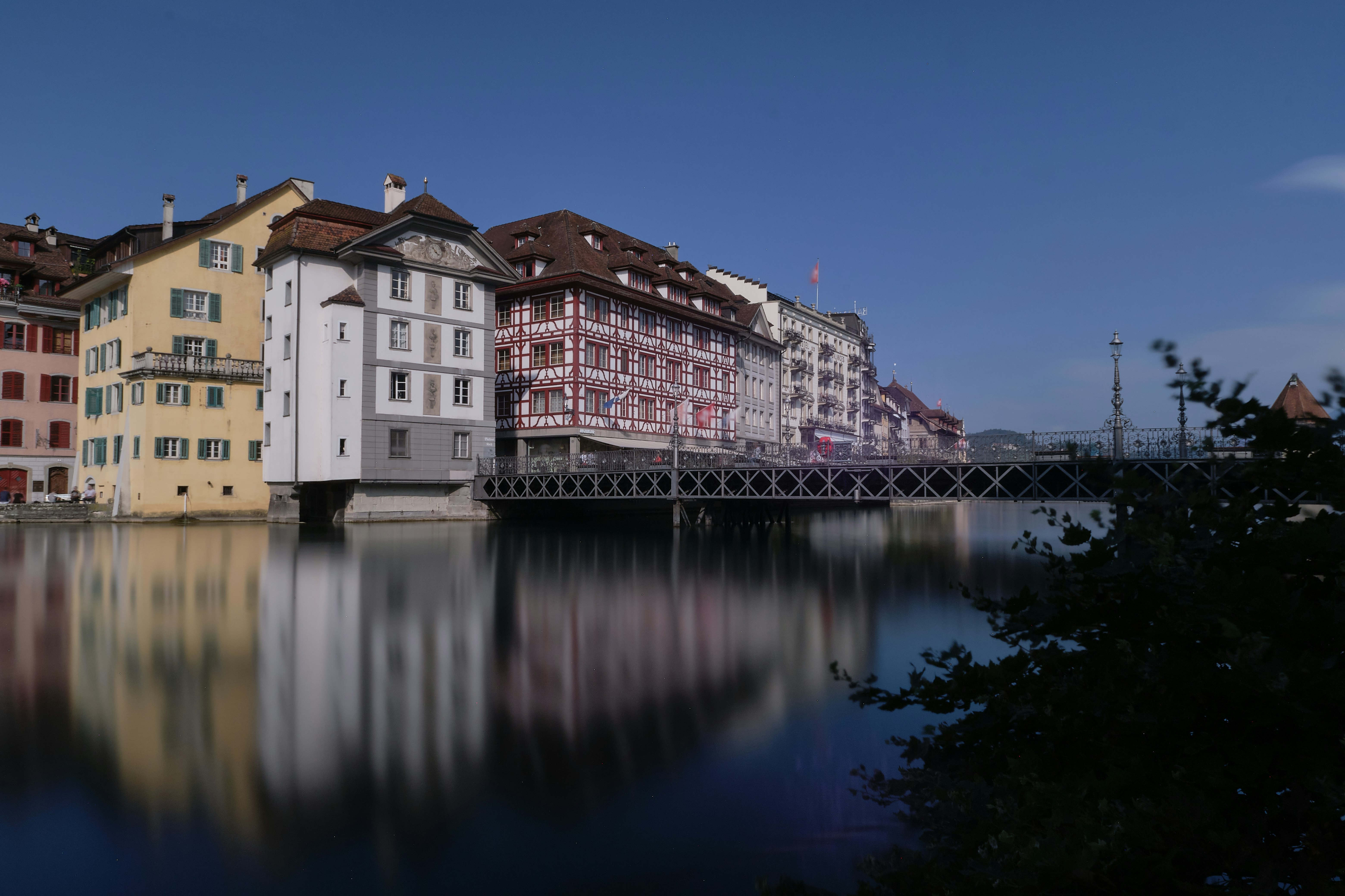 white and brown concrete building beside body of water during daytime